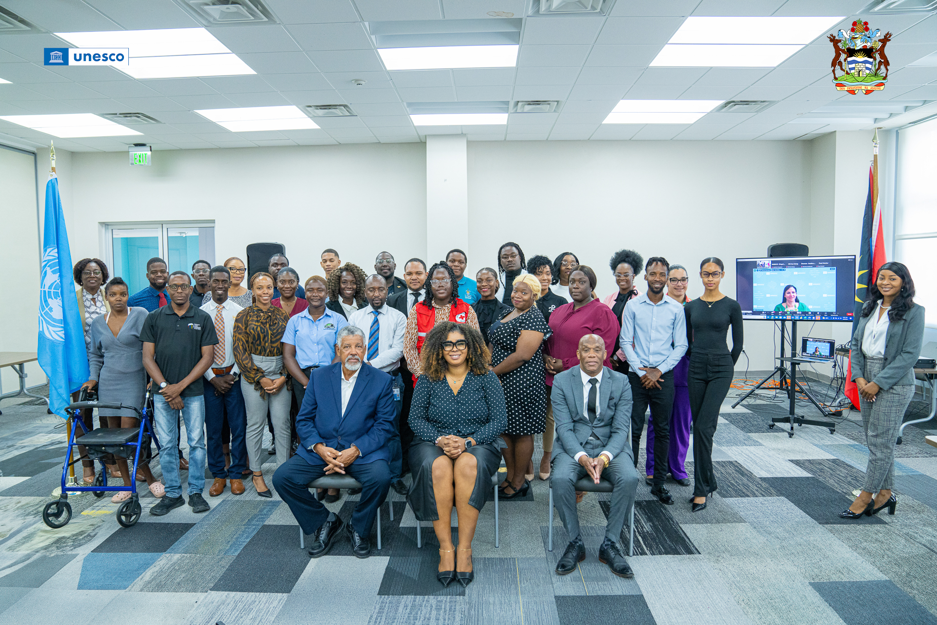 A group photo of the youth stakeholders and the members of the head table at the Opening Ceremony. Dr. Anna Paolini, Director of the UNESCO Office for the Caribbean, joins the photo via the Zoom platform.